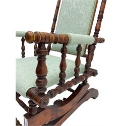 Early 20th century walnut framed American rocking chair, upholstered seat, back and arms