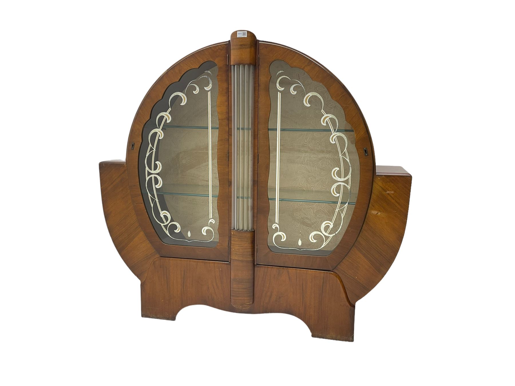 Art Deco walnut display cabinet, of circular design, fitted with two shaped glazed doors enclosing two glass shelves, flanking five glass rods