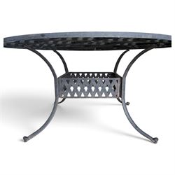 Grey-painted cast metal garden dining suite, comprising circular latticework table on splayed supports (W152cm H72cm), and six matching open armchairs with lattice backs and seats (W61cm H93cm)