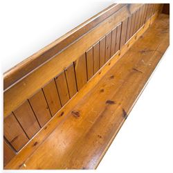 Early 20th century stained pine ecclesiastical church pew, the shaped end supports flanking slatted and panelled back, with black stencilled number '17' to the side