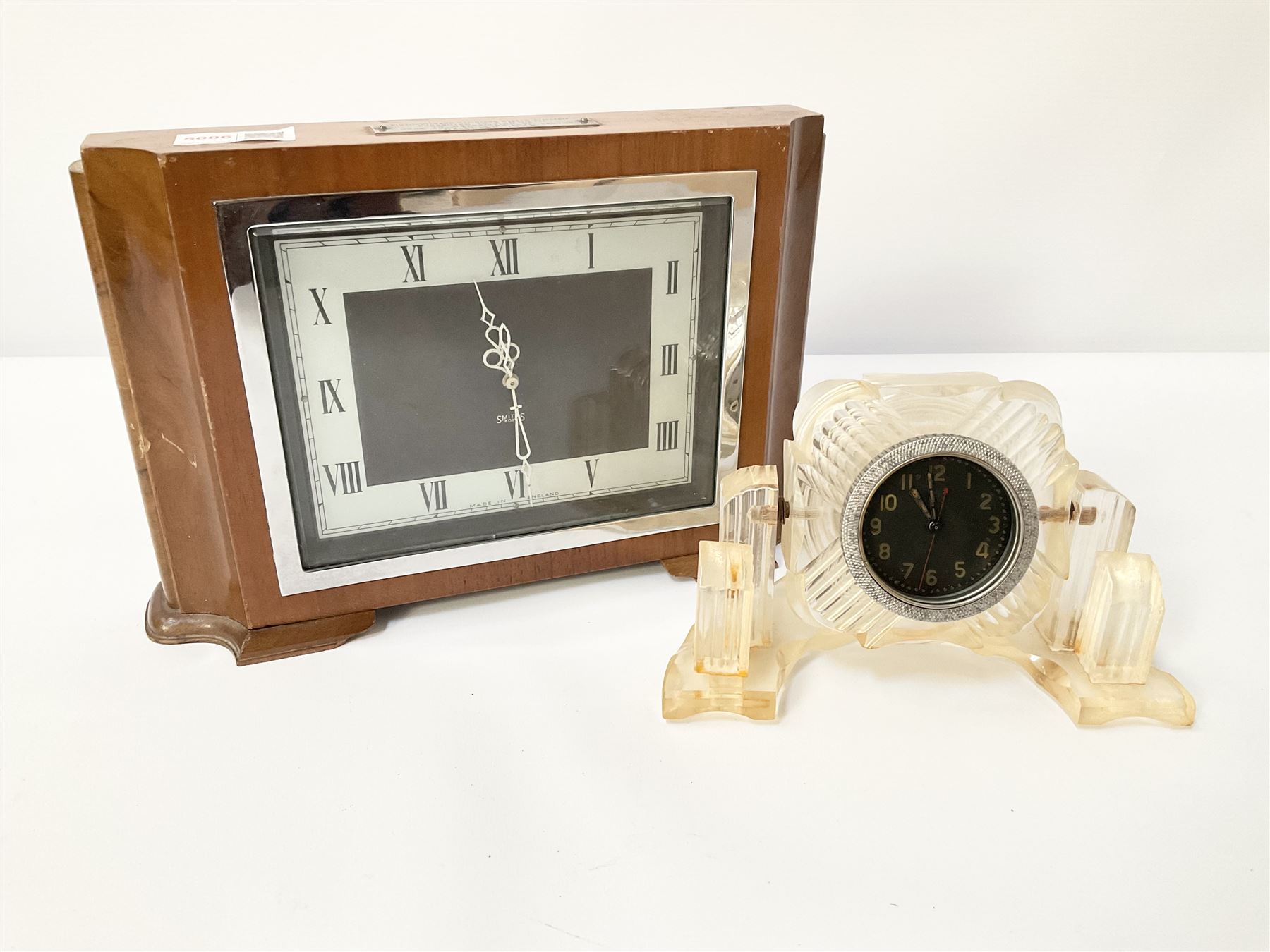 Two Art Deco style mantel clocks comprising a Smith’s 8 Day wooden clock and a clear geometric design clock 