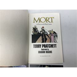 Terry Pratchett Discworld figures, designed by Clarecraft, comprising Mrs Gogol's house DW67, Death DW05, Windle Poons DW58, Death Swinging Scythe DW05A, Book Stamp from the Unseen University DW40, together with Mort a discworld big comic and discworld collectors manuals  
