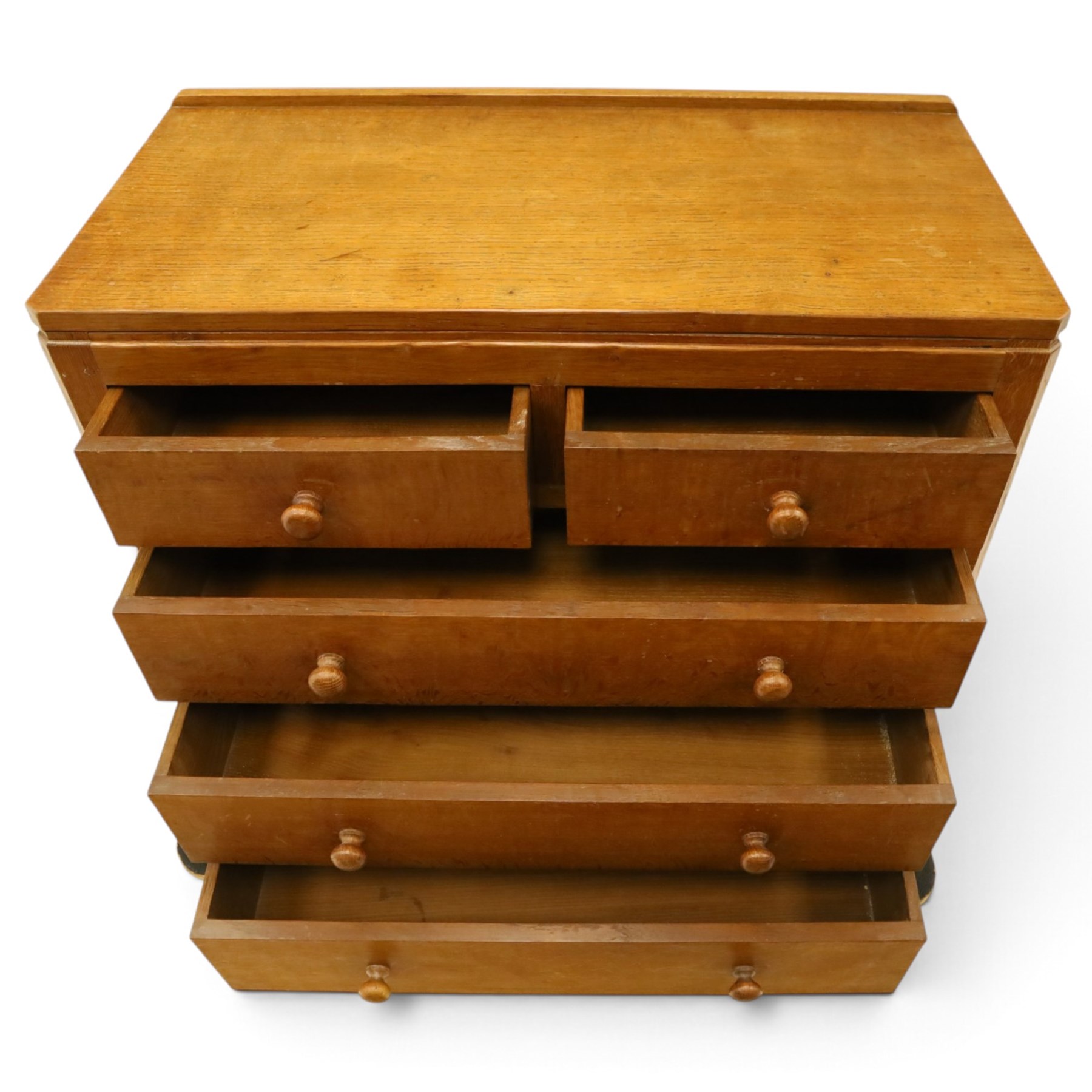 Mouseman - early-to-mid 20th century adzed and panelled oak chest, raised back over rectangular adzed top with canted corners, fitted with two short over three long drawers with turned knob handles, raised on octagonal feet, with carved mouse signature, by the workshop of Robert Thompson of Kilburn
