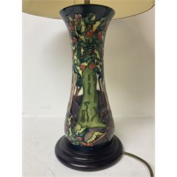 Moorcroft table lamp, of waisted form, decorated in the Holly Hatch pattern, on wooden plinth, with accompanying cream shade of lobed form, with piped detail, H33cm (excluding fitting)