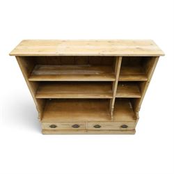 Late Victorian stripped pitch pine open bookcase, fitted with four adjustable open shelves, two drawers fitted to base with pull handles, on skirted base 