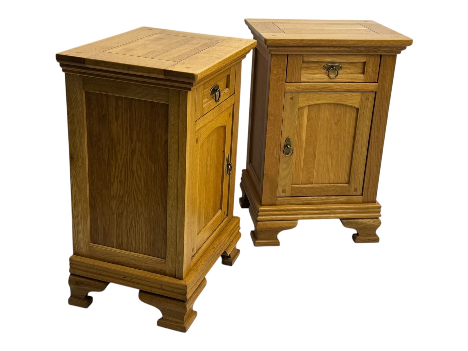 Frank Hudson - contemporary pair of light oak bedside cabinets, each with moulded rectangular top over single drawer above cupboard door with arched panel, on a moulded plinth base with bracket feet