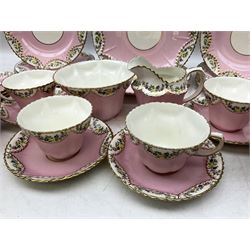 Late 19th/early 20th century Delphine Crown China tea service for twelve decorated with floral and gilt repeated patterned borders on pink ground