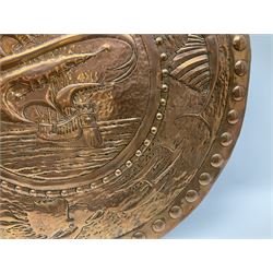 Large Arts and Crafts Newlyn School copper charger, repousse decorated with galleon to the centre surrounded by a continuous band of fish, D63cm