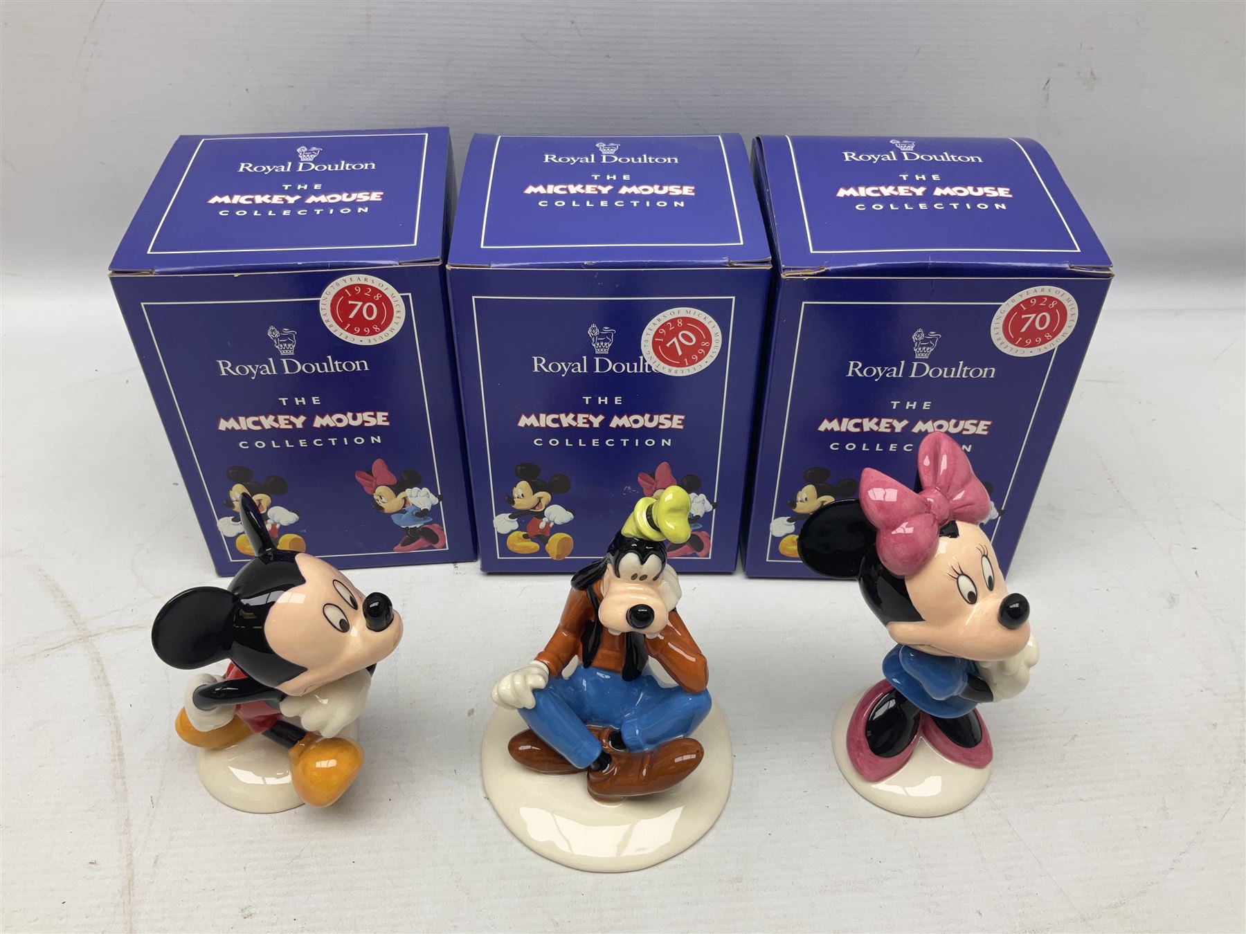 Three Royal Doulton The Mickey Mouse Collection figurines comprising Mickey Mouse MM1, Minnie Mouse MM2, and Goofy MM5, together withe three Royal Doulton limited edition miniature snowman character jugs comprising Christmas Stocking Snowman D7124, Christmas Cracker Snowman D7158 and Snowman D7062, all with original boxes 