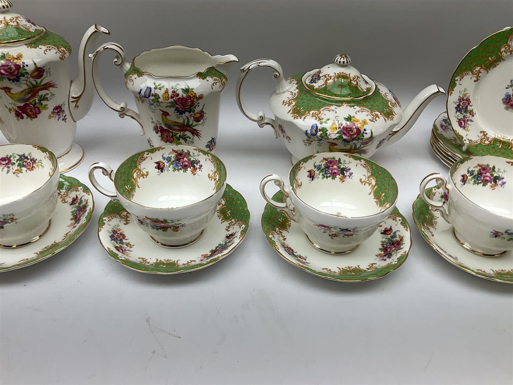 Paragon Rockingham pattern tea set, comprising teapot, coffee pot, four teacups and four saucers, six side plates, six dessert plates, cake plate, two open sucriers, and jug. 