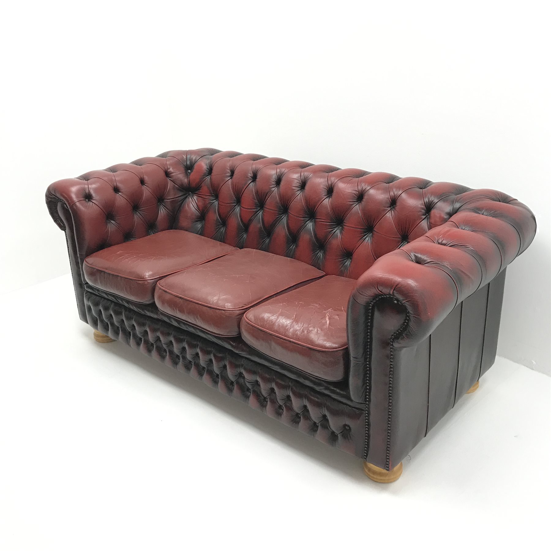 Three seat Chesterfield sofa upholstered in deep buttoned Ox blood