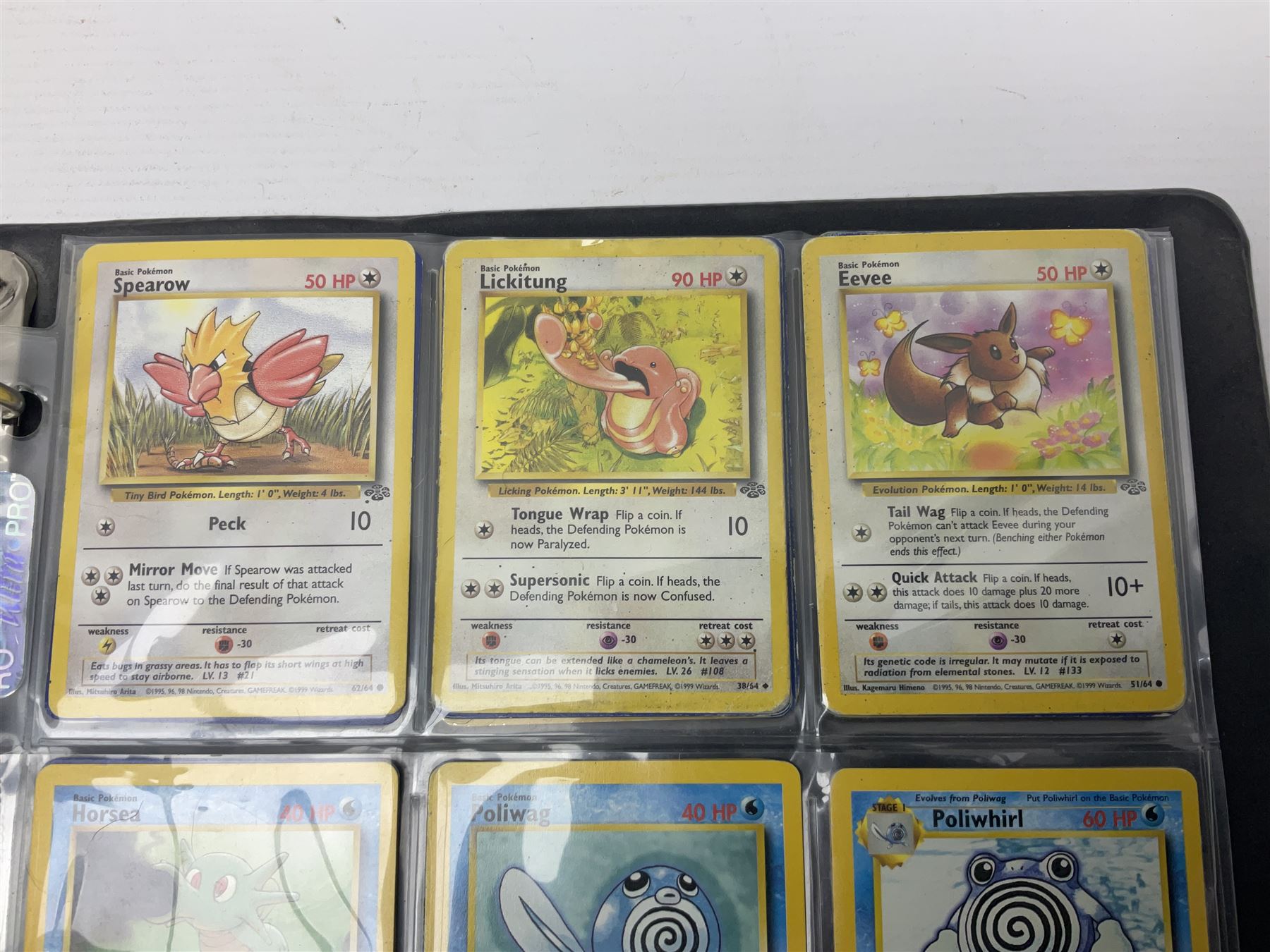 Collection of Pokemon trading cards, mostly 1999 Wizards Pokemon cards to include holo Charizard 4/102, first edition holo Machamp 8/102, further holographic cards; Dark Flareon 35/82 and Dark Vaporeon 45/82, cards from themed sets and 4th edition prints; 1998 Electronic Pokédex with cardboard boxes for themed decks Blackout, Overgrowth and Power Reserve Jungle, along with a large quantity of energy and trainer cards 