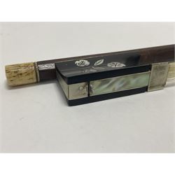 19th century wooden violin bow with a decorative mother of pearl inlay depicting flowers to the frog, with a bone adjuster screw