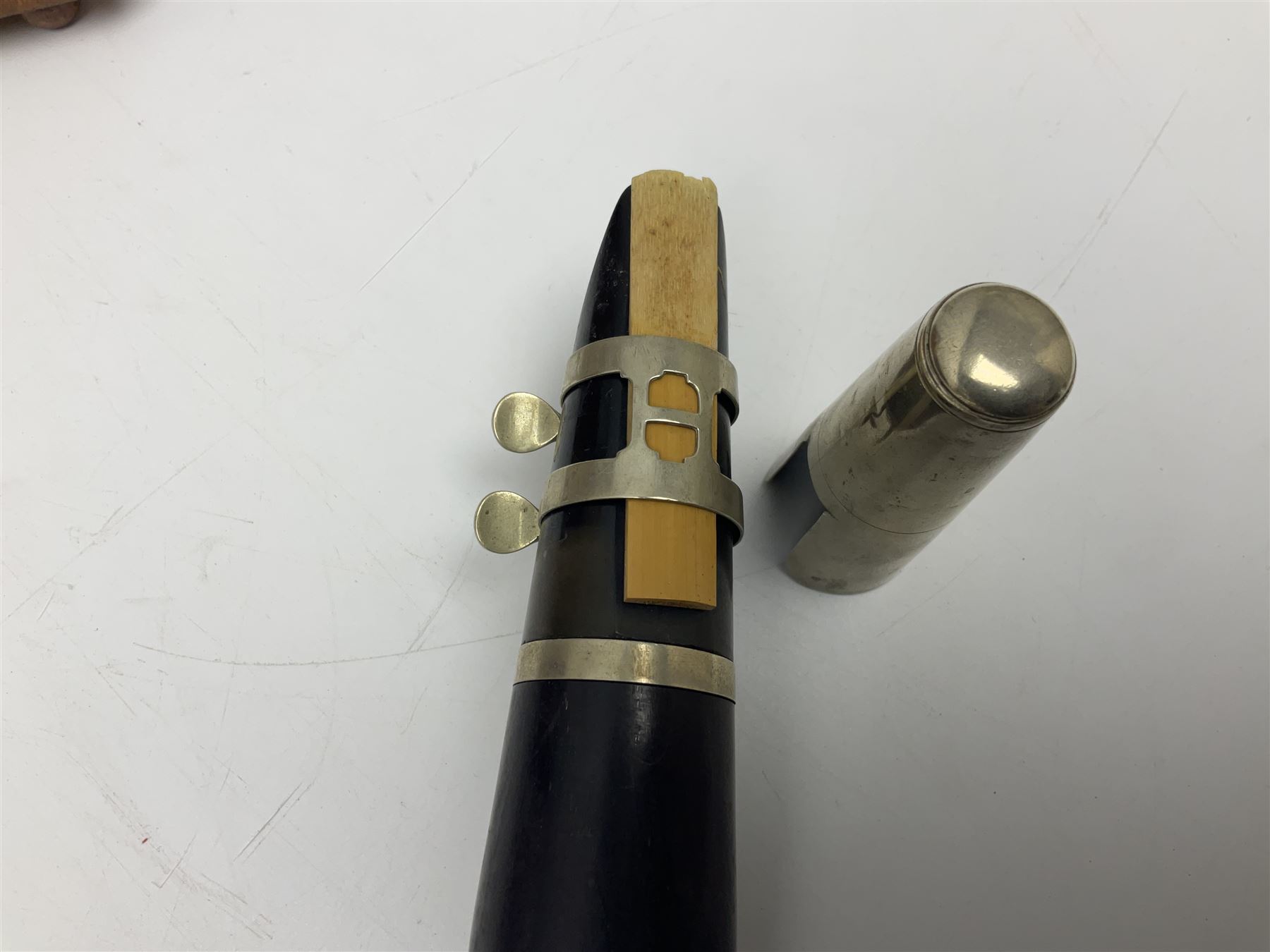 Early 20th century Hawkes and Son simple system hardwood clarinet serial no.1HM257102; cased; and a Swiss Maelzel BS Dulcet metronome of typical pyramid form (2)