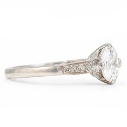 Early 20th century platinum diamond ring, four claw set with a single old cut diamond of approx 0.90 carat and diamond set shoulders, stamped Plat, inscribed with initials and dated 7.6.28