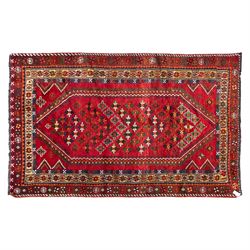 South West Persian Lori hand-knotted rug,  deep crimson field with a stepped lozenge medal...