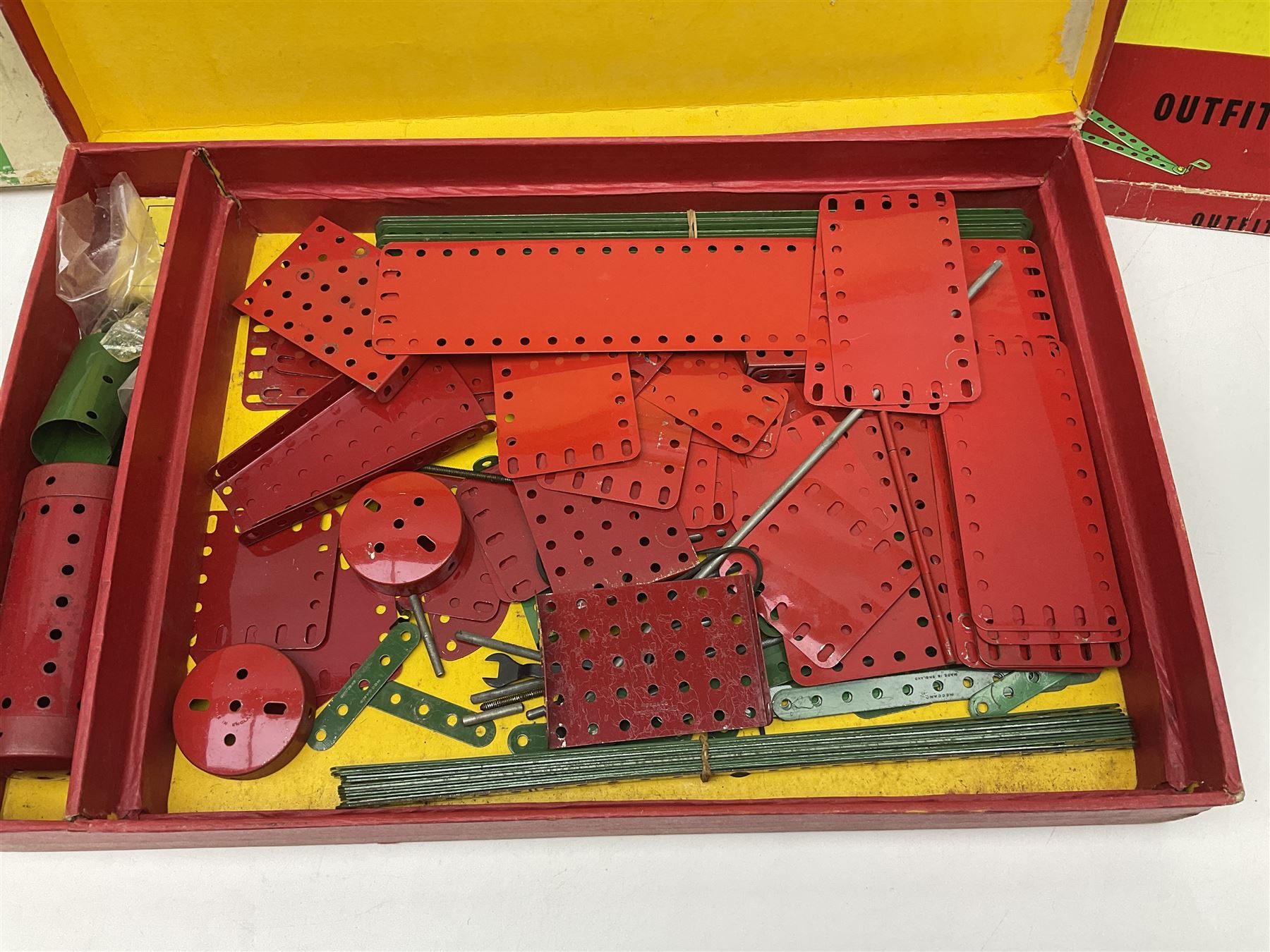 Meccano - Outfits 4, 6 & 7 with red and green parts; Outfits 4 & 6 virtually fully stocked and Outfit 7 containing large quantity of loose parts; Outfits 4 & 7 with instruction manuals; all boxed (3)