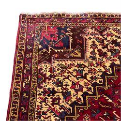 Persian Hamadan red ground rug, decorated with stylised plant motifs, the band border with repeating design