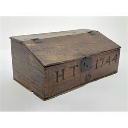 18th century boarded oak desk box, the sloped hinged lid with moulded edge, above front inscribed 'H.T 1744' and carved with star motif, with iron lock and hinges, opening to reveal an interior fitted with single shelf, H30cm L73cm D40cm 