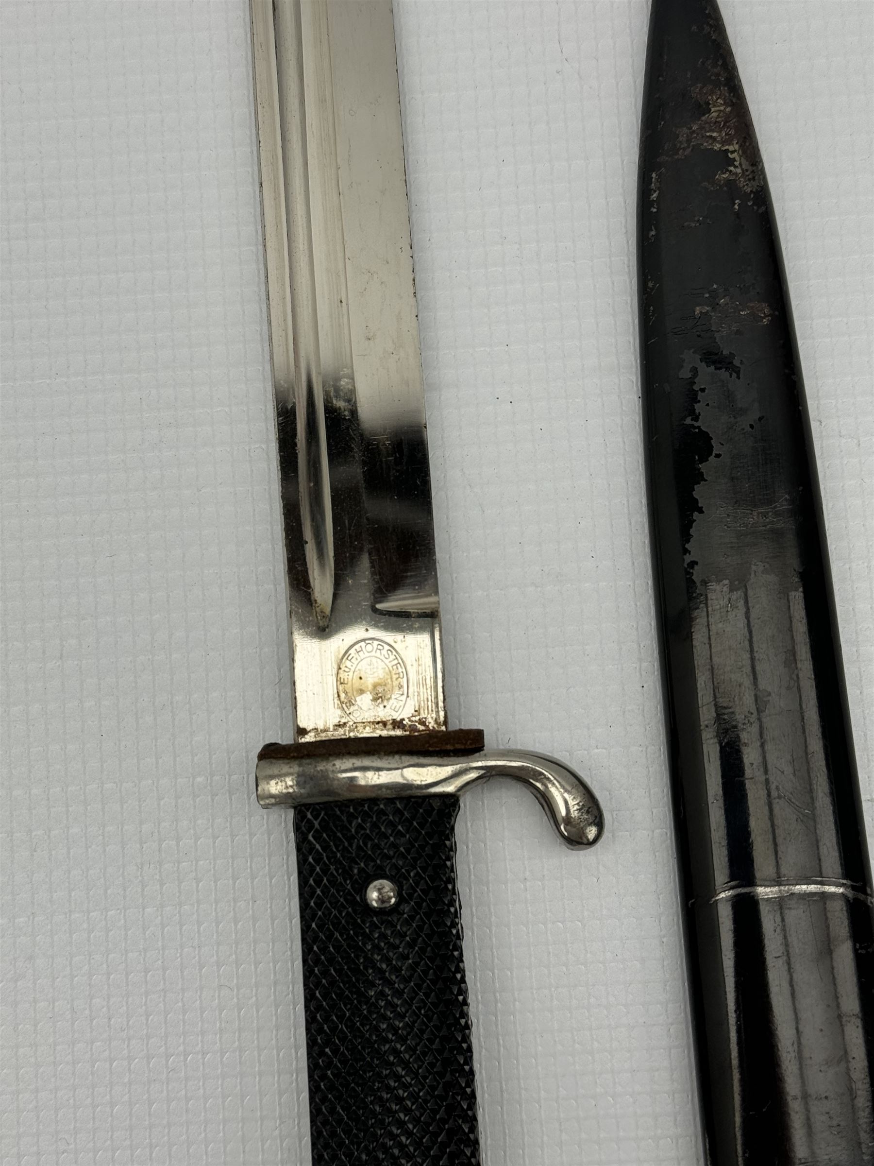 German Third Reich bayonet, the steel blade stamped E & F Horster, Solingen with black plastic chequered grip scales, L35cm