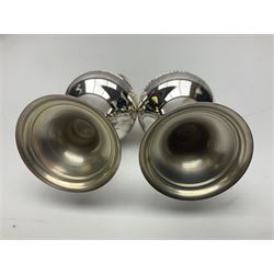 Silver plated two piece cruet set, comprising salt shaker and pepper shaker, both of waisted form with engraved rope twist borders, the removable pierced covers each with engraved lattice decoration, upon a circular spreading foot, H13.3cm, contained within velvet lined fitted case
