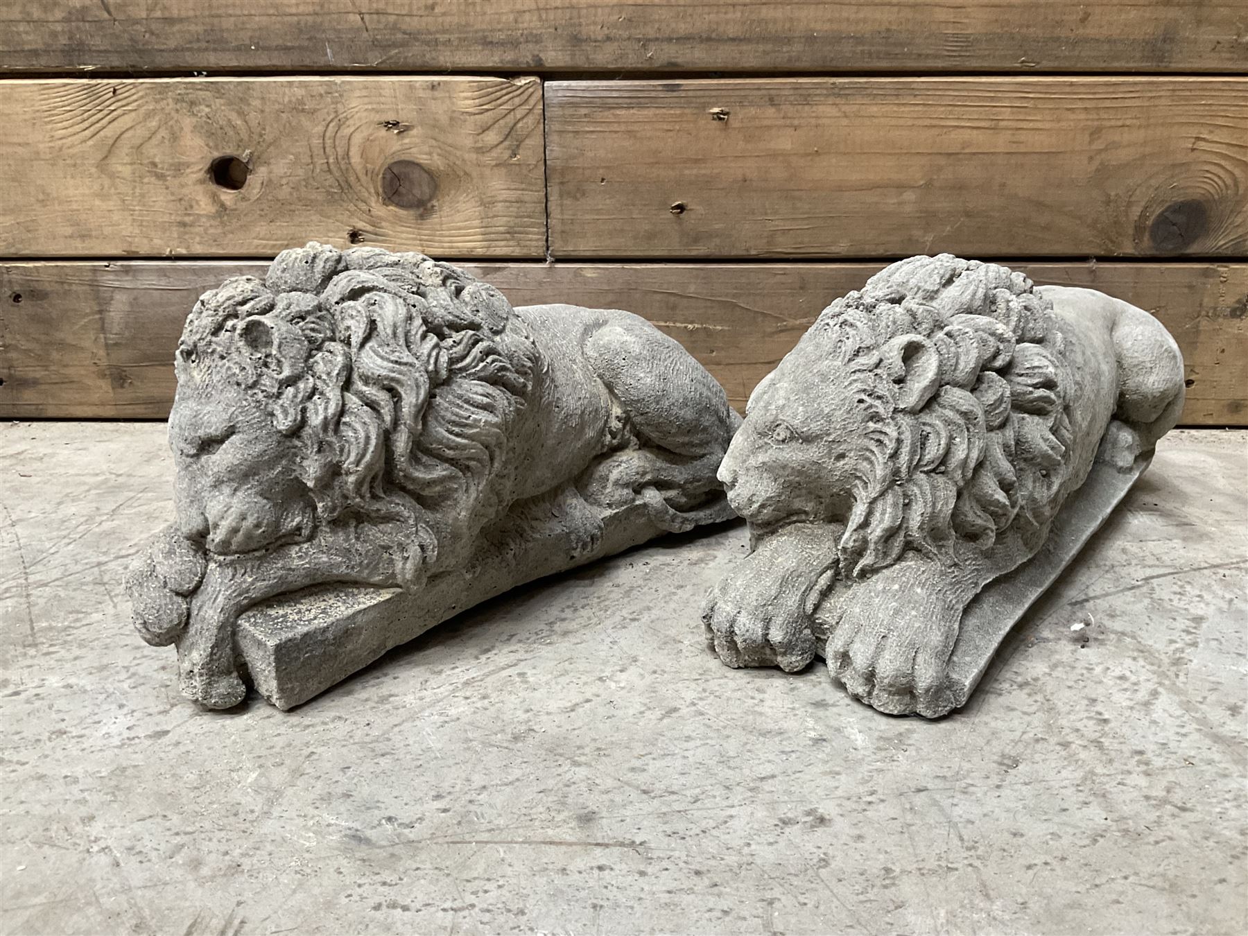 Pair of small cast stone sleeping Trafalgar Lions