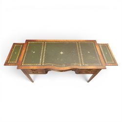 Regency style mahogany writing desk, serpentine front tooled green leather inset, slides to either side, central frieze drawer, flanked by a bank of two drawers, square tapering supports