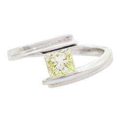Platinum diamond ring, tension set with a single princess cut fancy yellow diamond of appr...