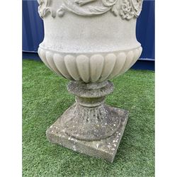 Composite stone campana shaped urn, the body decorated with scrolling foliage, gadroon moulded underside, fluted pedestal support on square base - THIS LOT IS TO BE COLLECTED BY APPOINTMENT FROM DUGGLEBY STORAGE, GREAT HILL, EASTFIELD, SCARBOROUGH, YO11 3TX