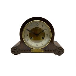 An oak cased 1930’s eight-day German mantle clock manufactured by HAC (Hamburg Amerikanische Uhrenfabrik), spring driven movement with a recoil anchor escapement striking the hours and half hours on a coiled gong, in round case with silvered chapter ring with Arabic numerals and minute markers, steel spade hands within a brass bezel and convex glass. With a presentation plaque to the front of the case. With pendulum.


