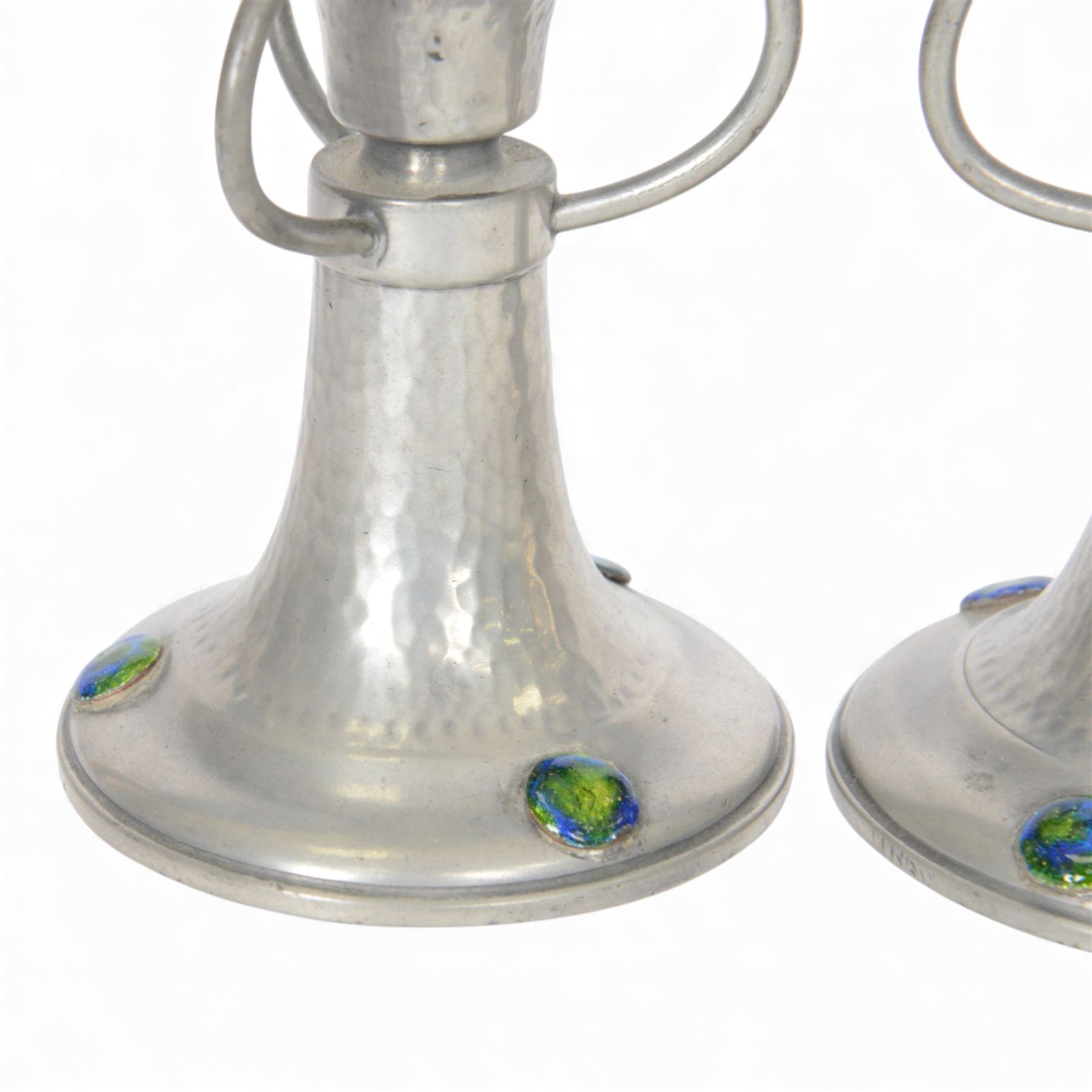 Pair of  Jugendstil hammered pewter candlestick each set with three blue and green enamel roundels, marked Germany beneath, H12cm