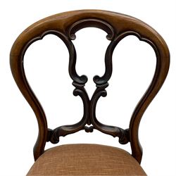 Set of four Victorian rosewood dining chairs, the balloon back carved and moulded with C and S scrolls, the padded serpentine front seat upholstered in shell pink fabric, on cabriole supports with moulded knees