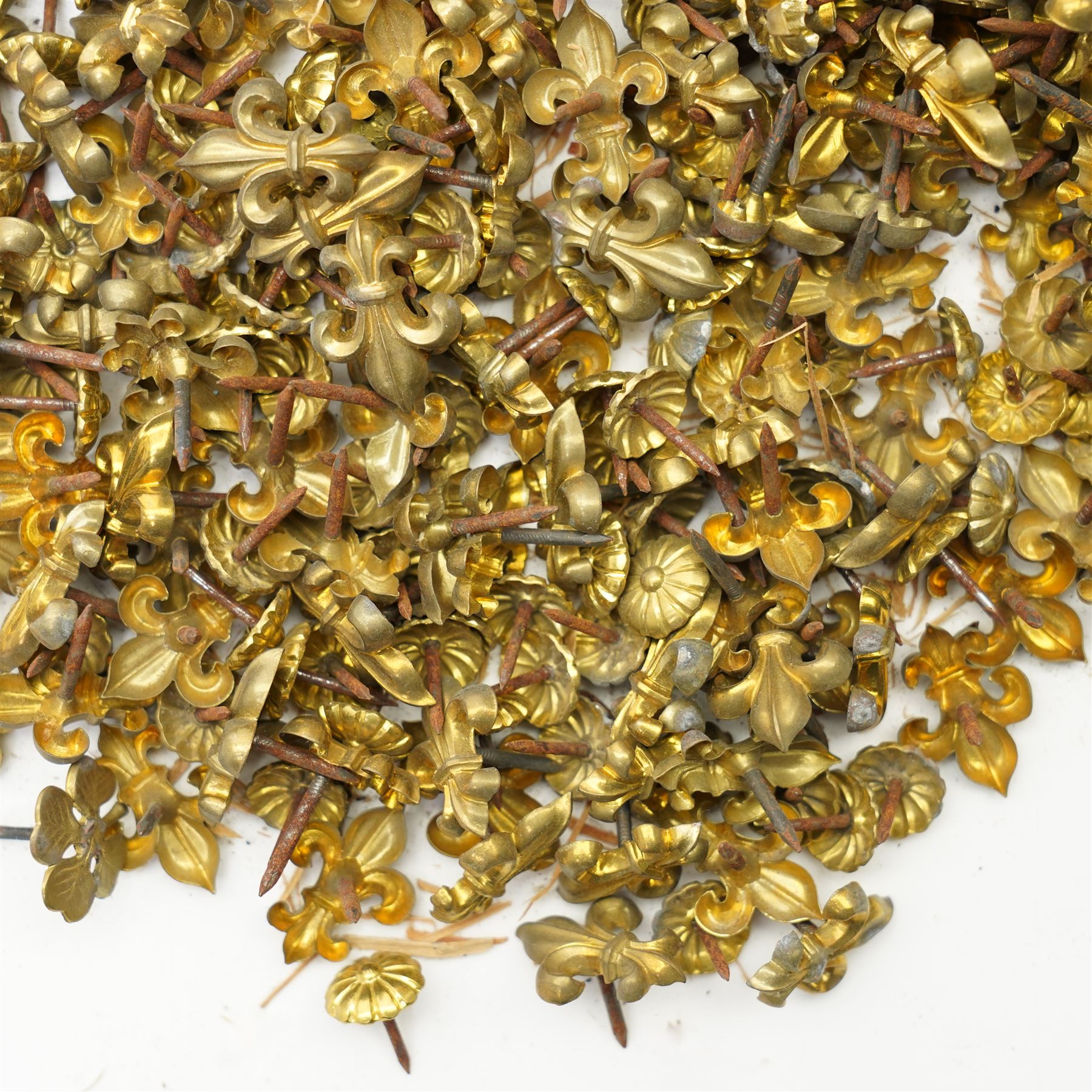 Large quantity of Victorian brass upholstery pins with rosette and fleur de lis designs 
Provenance: property of a Nobleman