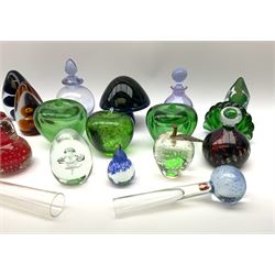 A group of glass paperweights modelled as various fruit, to include examples by Wedgwood, and examples with controlled bubble decoration, together with a selection of other paperweights of various form and design, two marked Wedgwood, two lilac coloured bottles with stoppers, and two bud vases with controlled bubble decoration to the globular bases. (18). 
