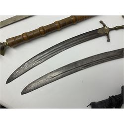 Near pair of short swords each with slightly curving 41cm fullered steel blade and all brass H-shaped hilt L52cm overall; plaited black leather whip; and reproduction pair of brass hilted swords, brass halberd blade and mace (7)