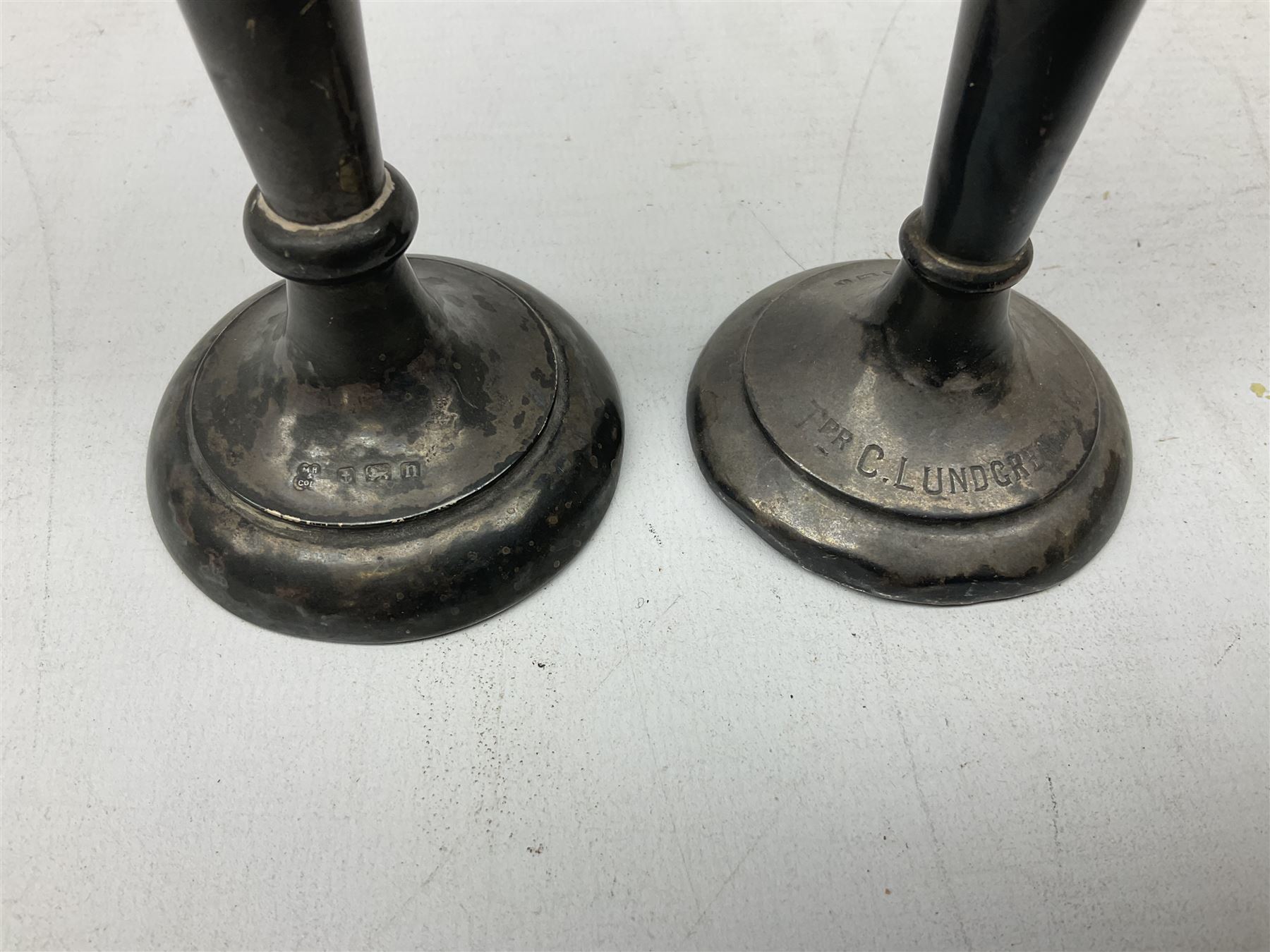 Two early 20th century silver trumpet vases to include a Martin Hall & Co Ltd example, silver circular box raised on three feet stamped Birmingham 1912, ashtray hallmarked London 1945, silver backed hair brush with engine turned decoration etc, tallest H19.5cm