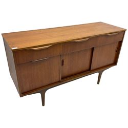 Mid-20th century circa. 1970s teak sideboard, three drawers over fall front cupboard and two sliding doors, on tapering supports