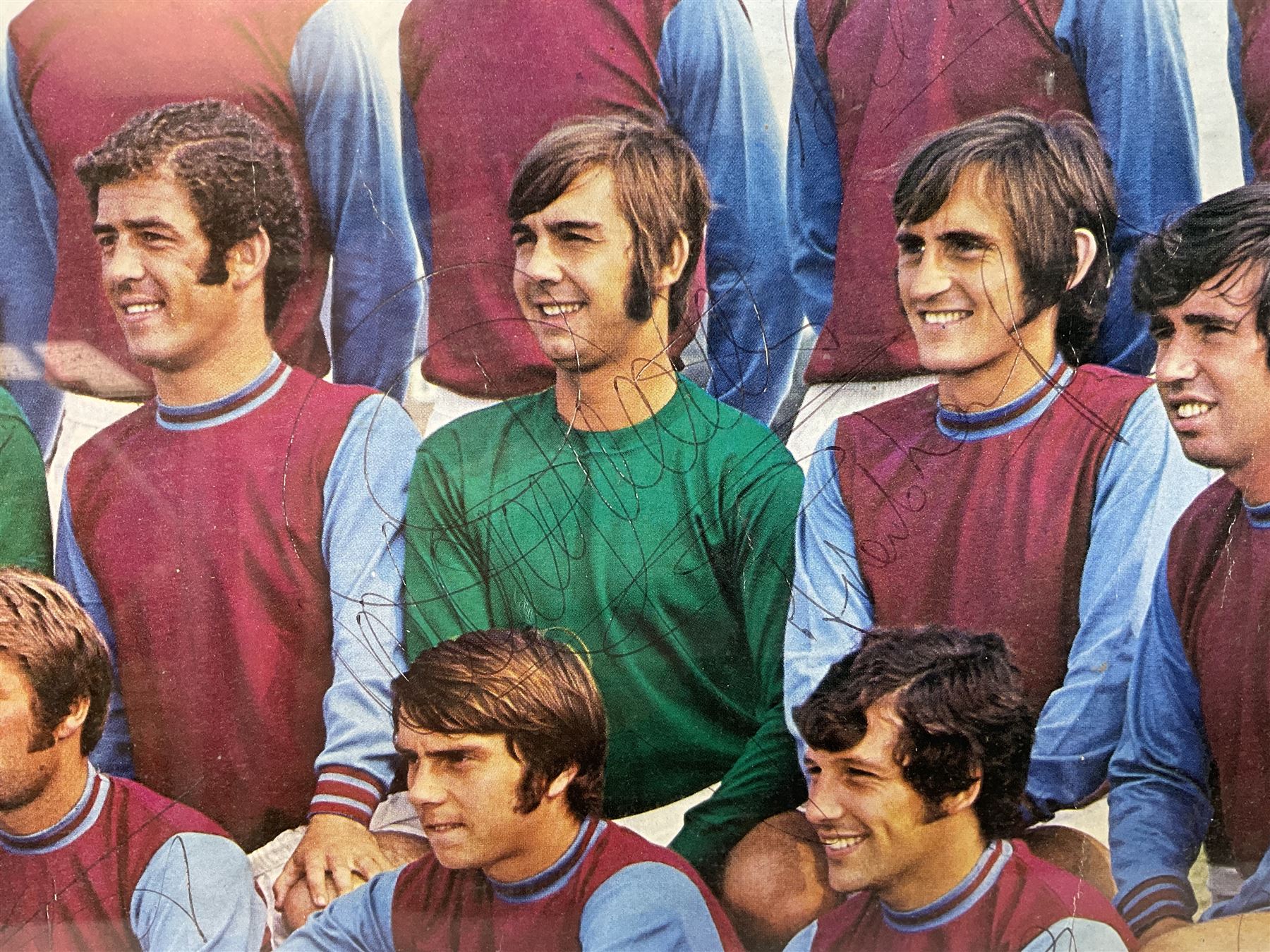 1970-1 photograph of West Ham United FC squad members, including Bobby Moore, Geoff Hurst, Harry Redknapp, Trevor Brooking, Jimmy Greaves, Billy Bonds etc, most players with signatures, 30 x 45cm, framed and glazed