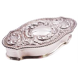 Edwardian silver dressing table box, of shaped oval form, the hinged cover embossed with vacant central panel, scrolling foliate surround, and oblique gadrooned rim, hallmarked William Hutton & Sons Ltd, Birmingham 1901, W13cm, approximate weight 3.83 ozt (119 grams)