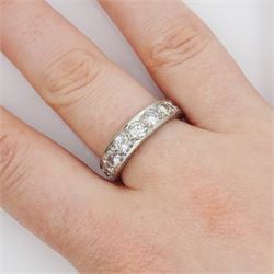White gold seven stone round brilliant cut diamond ring, the sides with engraved decoration, stamped 18ct, total diamond weight approx 1.15 carat