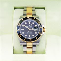 Rolex Oyster Perpetual Submariner Date gentleman's stainless steel and gold automatic wristwatch, Ref. 116613LN, serial No. 8201P7C5, back dial with luminous hour markers, unidirectional rotating black ceramic bezel, on stainless steel and yellow gold Rolex Oyster bracelet with fold-over clasp, boxed with guarantee card dated 2013