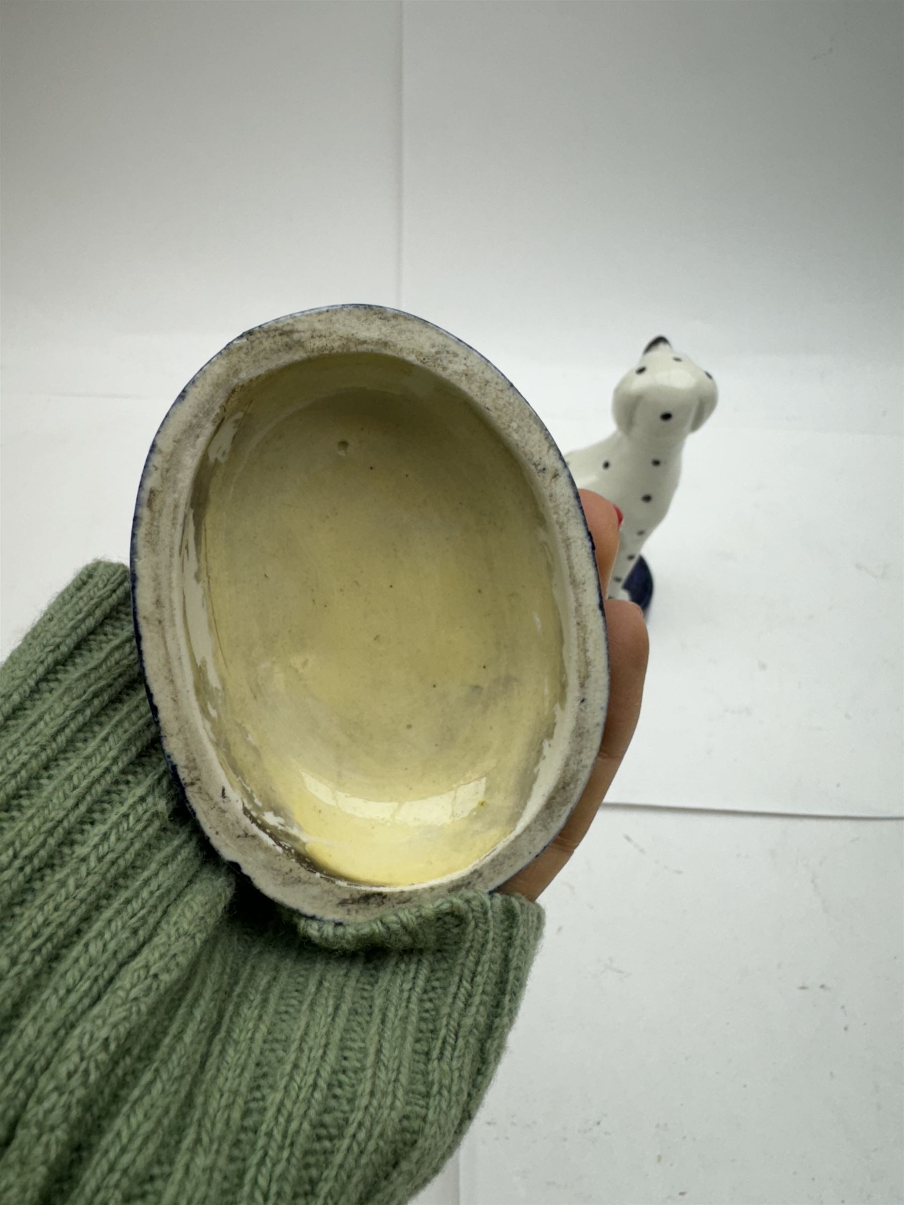 Pair of Staffordshire figures modelled as chained Dalmatians seated upon cobalt blue oval bases, H13cm, together with a Staffordshire pastille burner modelled as a castle, H12cm, a pair of 19th century Derby potpourri pots (lacking covers), and an 18th century blue and white tea bowl 