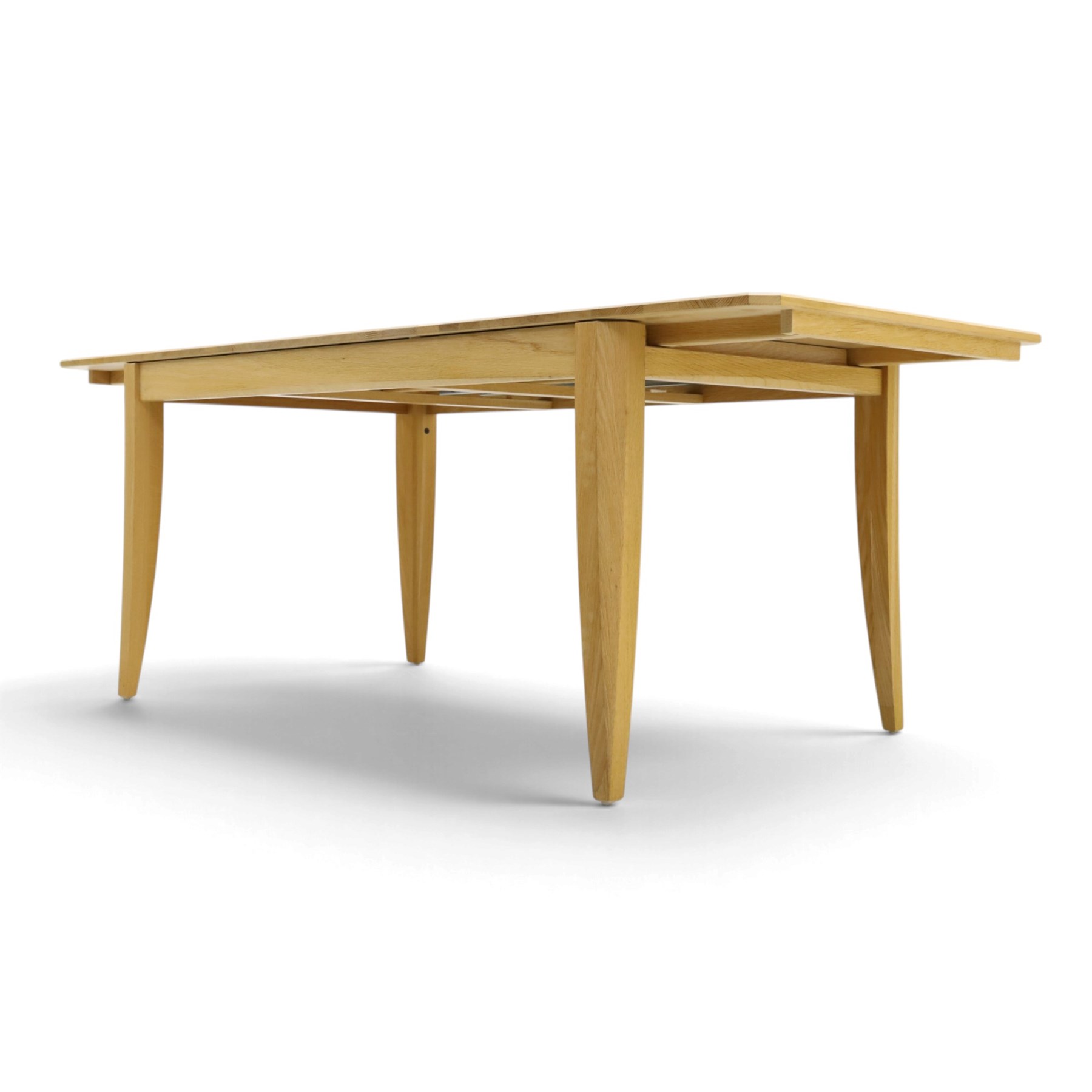 Ercol - 'Artisan' light oak extending dining table, rectangular top with canted corners, with stowable leaf extending the table to 193cm, shaped faceted supports