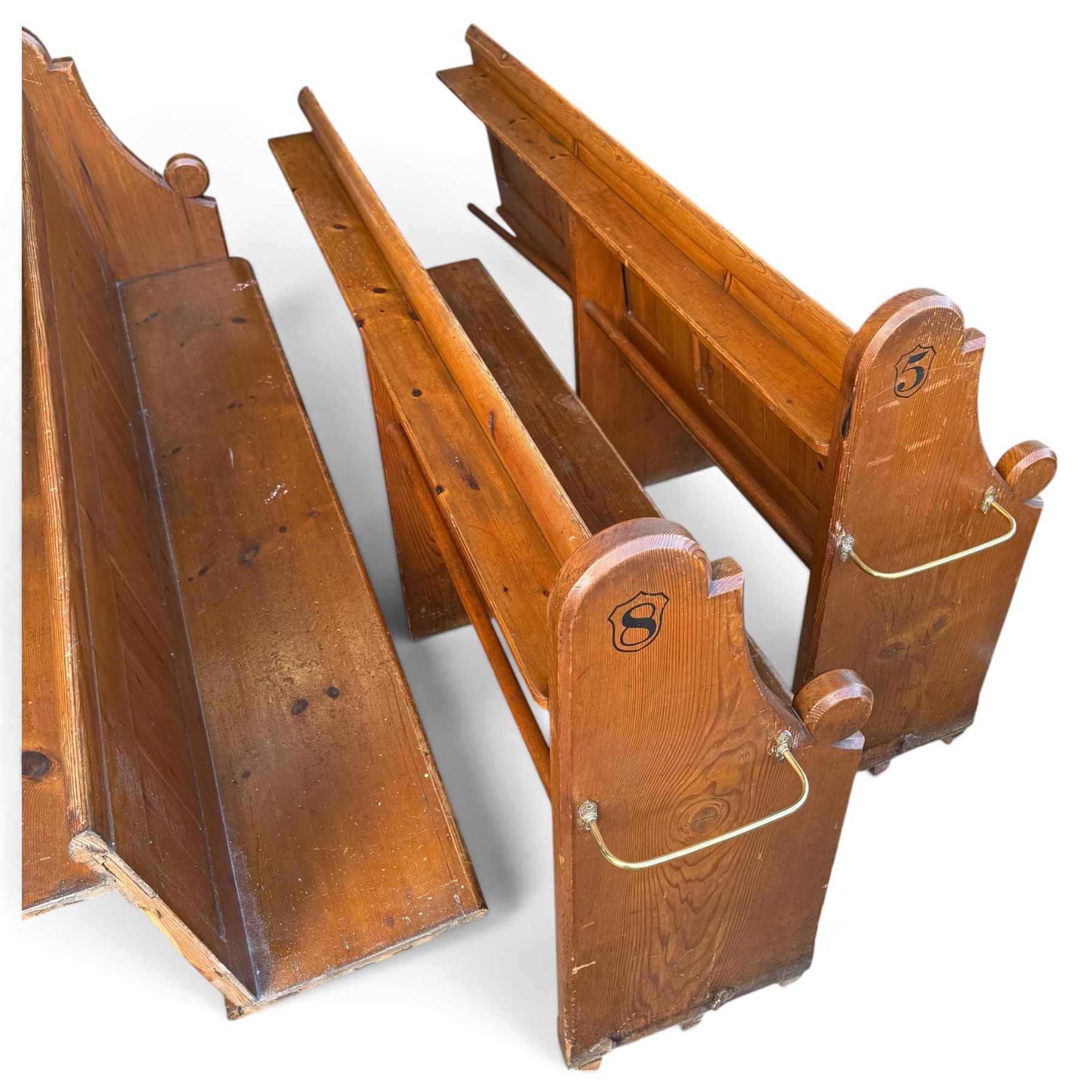 Set of four early 20th century single-ended stained pine ecclesiastical church pews, the shaped end support flanking slatted and panelled back