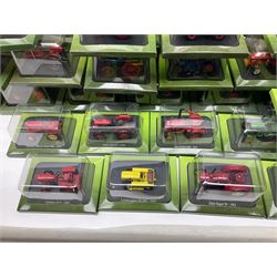 Eighteen issues of Tractors and The World of Farming magazine, together with sixty diecast tractors, all in original packaging, in three boxes 