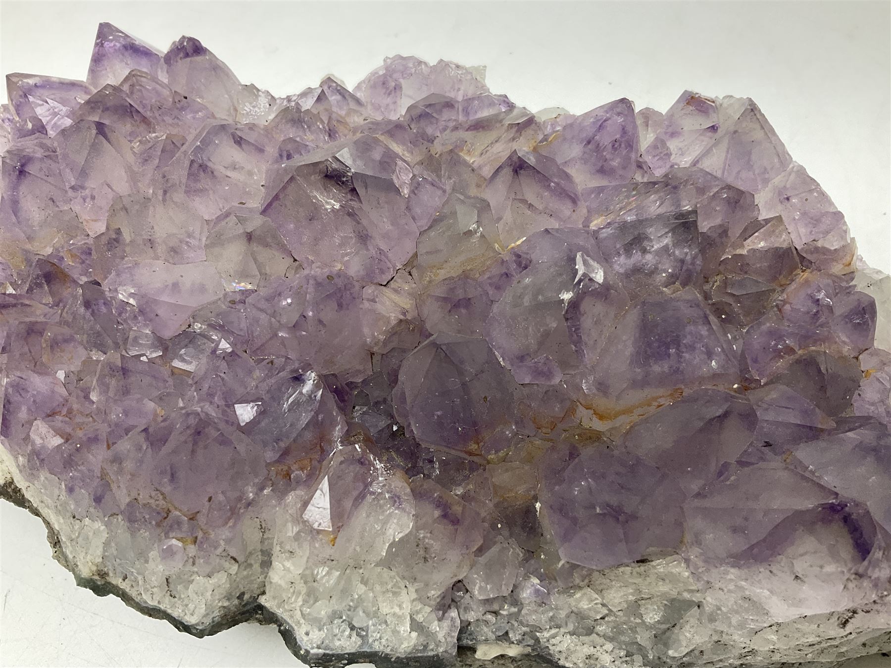 Amethyst crystal geode cluster, with well-defined crystals of various sizes, H10cm, L30cm