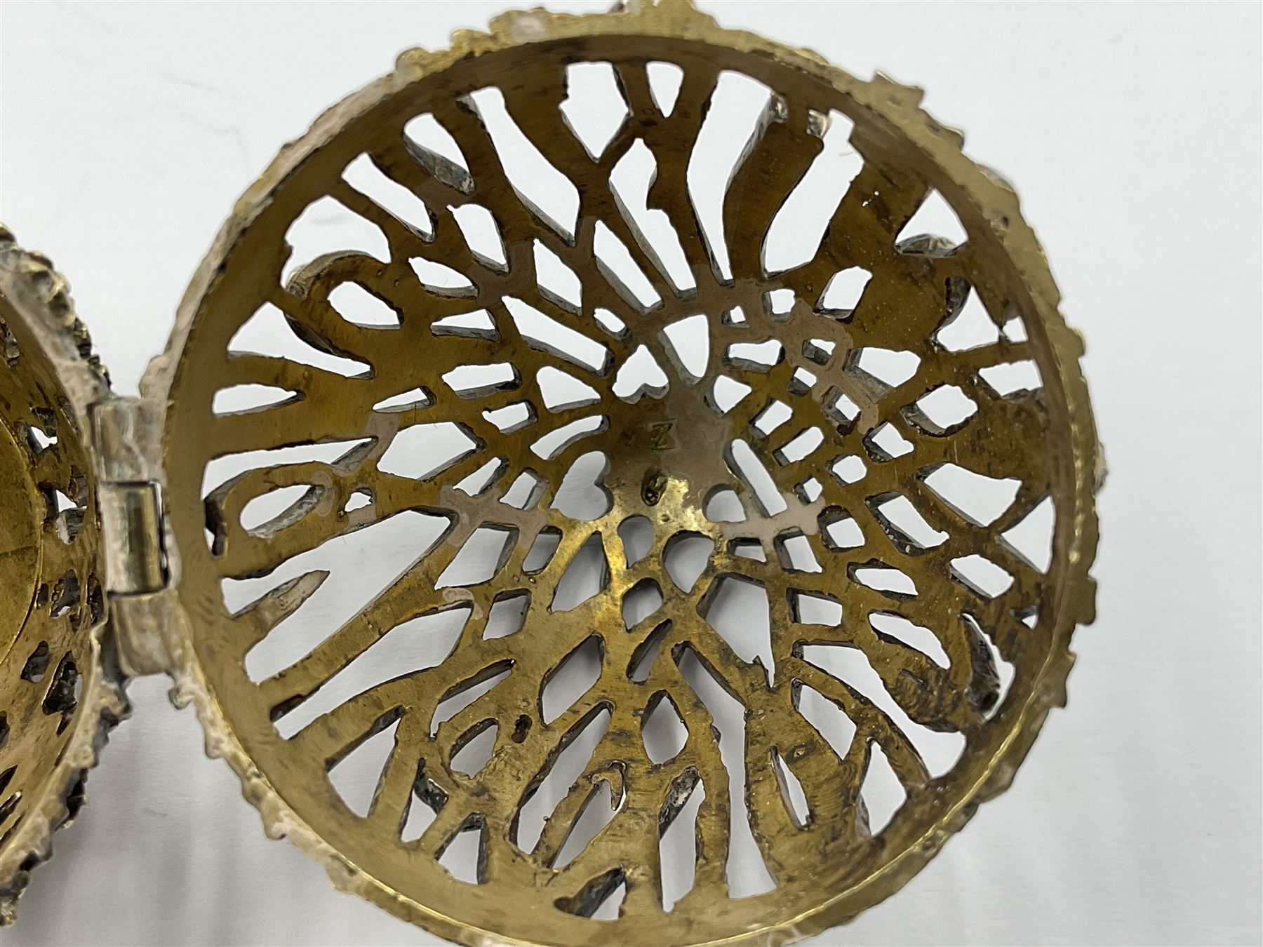 Modern silver limited edition Easter egg, no. 70/500, the gilt openwork body decorated with cascading bluebells and hinged cover with pierced circular panel set with a single faceted purple stone, opening to reveal a gilt interior, upon silver stand with three scrolling pad feet, each hallmarked St James House Company, London 1981, height including stand 8cm