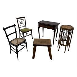 Late 19th century black-painted cane seat chair; early 20th century radial spindle-back chair with green upholstery; early 20th century mahogany single-drawer side table; mid-20th century carved wooden stool with harp motif; early 20th century hexagonal bamboo stand; two oval mirrors (7)