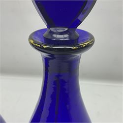 Pair of early 19th century blue glass decanters with teardrop stoppers, with gilt writing, the first marked Gin the second Brandy 