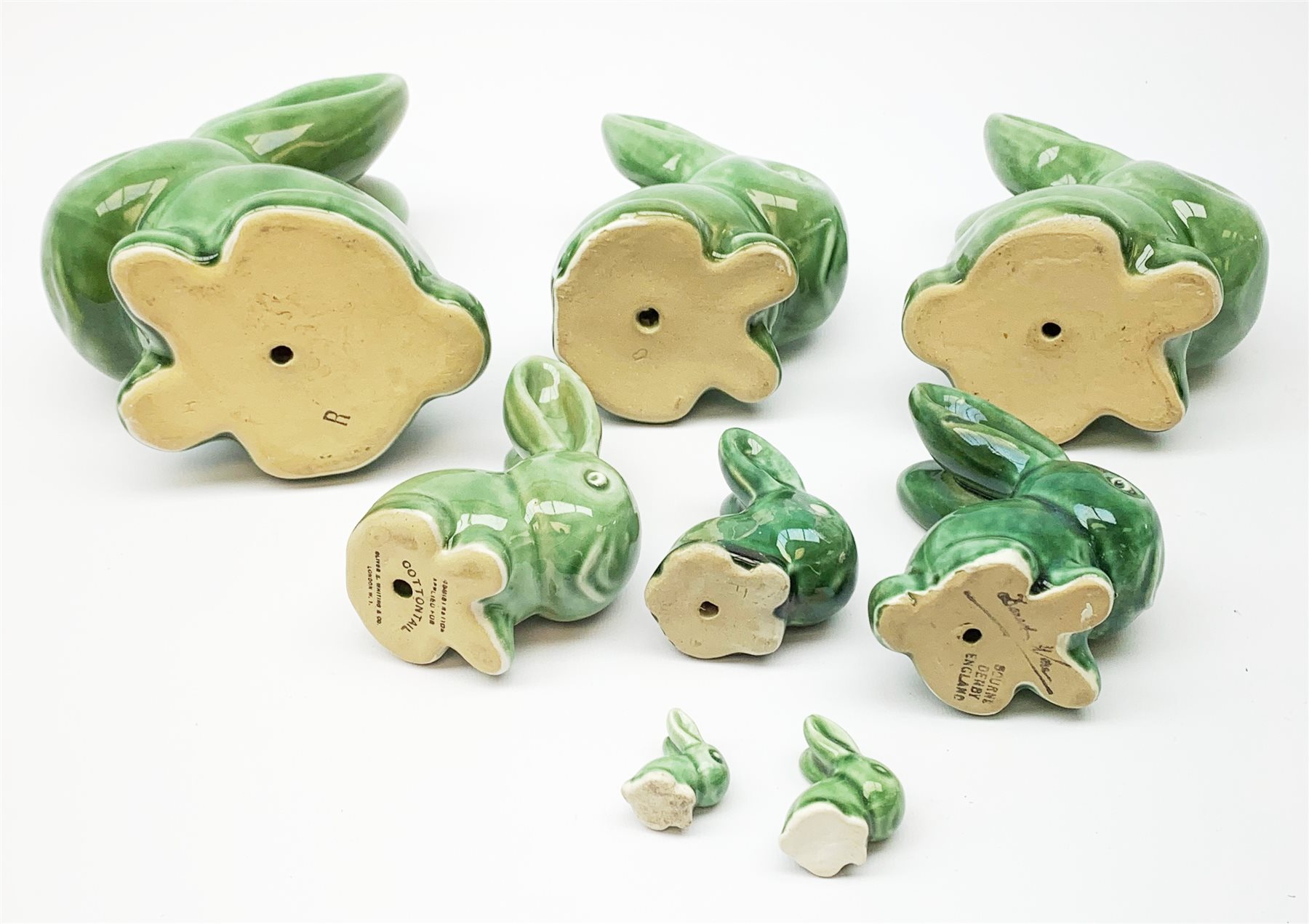 A collection of eight Denby green glazed models of the Rabbits Marmaduke and Cotton tail, various sized, largest H20.5cm, some marked. 